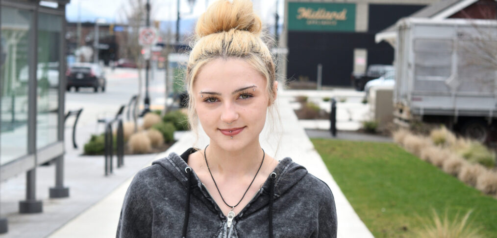 Blonde haired girl posing for a picture.