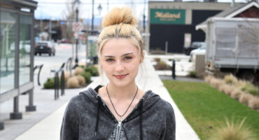 Blonde haired girl posing for a picture.