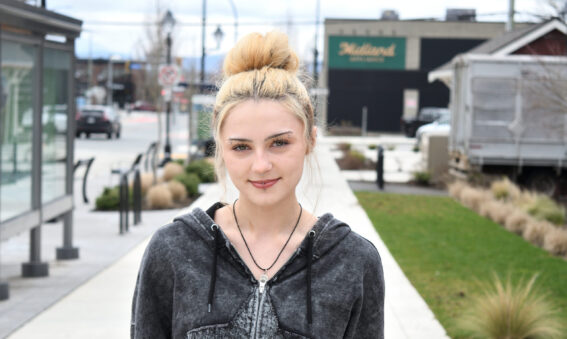Blonde haired girl posing for a picture.