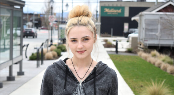 Blonde haired girl posing for a picture.
